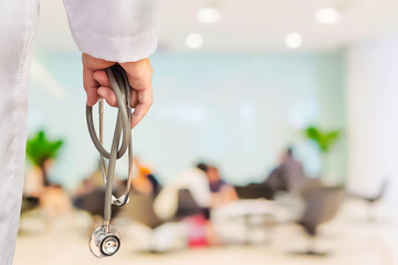 Doctor is going to examine his patient using his stethoscope over sitting people in modern hospital background