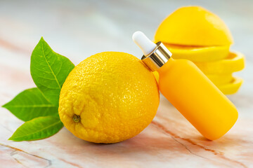 Wall Mural - Serum in a cosmetic bottle next to an orange. Natural cosmetics and face care.