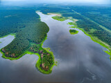 Fototapeta  - Big lake with green shores in bright sun light, aerial landscape. Recreation concept. Aerial view