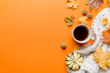 Wall Mural - flat lay composition with colorful autumn cup of coffee and leaves on a color background. top view
