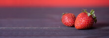 Two Juicy Strawberries Lying On A Wooden, Dark Background. Copy Space.