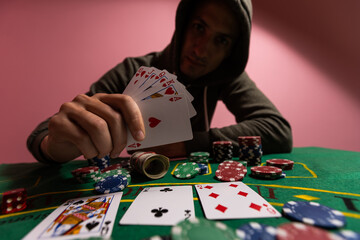 Wall Mural - Happy poker player winning and holding cards.