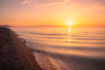 Lovely romantic warm sunrise at the Sicilian East Coast in Italy, Europe 