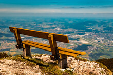 Details Of A Wooden Bench And The Far Away City Of Salzburg At The Famous Untersberg Mountain, Groedig, Salzburg, Austria
