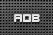 © bankrx - White alphabet letter in word AOB (abbreviation of Assignment of benefits or Any other business) on black pegboard background