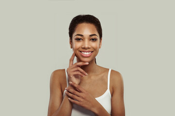 Wall Mural - Portrait of happy attractive joyful smiling young black woman on white background