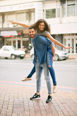Poster - He likes to do anything with me, absolutely anything. Shot of a playful couple out in the city together.