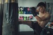 Male boxer hitting a punching bag with boxing gloves at the gym