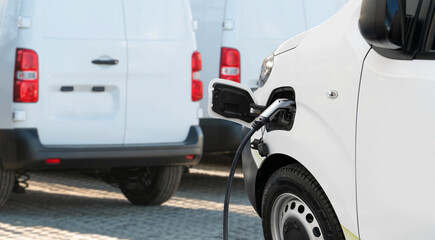 Sticker - Electric delivery van with connected charging cable. 