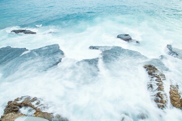 Sticker - Beautiful shot of a brown rocky shore with ocean waves