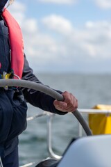 Sticker - Closeup shot of someone at the wheel of a sailing yacht