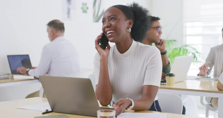 Poster - Businesswoman talking on a call on a phone and using laptop in an office with colleagues. Entrepreneur laughing having a conversation on a phone while planning ideas at her desk in a startup agency