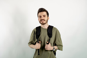 Wall Mural - Caucasian young man wearing t-shirt posing isolated over white background posing education in high school university college concept.