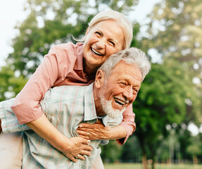 woman man outdoor senior couple happy lifestyle retirement together smiling love fun elderly active vitality nature mature portrait piggyback game