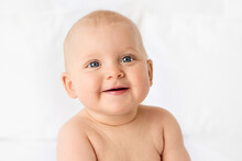 Portrait Of Smiling Chubby Baby Girl With Blue Eyes