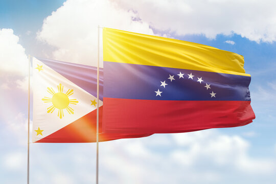 Sunny blue sky and flags of venezuela and philippines
