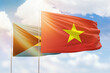 Sunny blue sky and flags of vietnam and bahamas