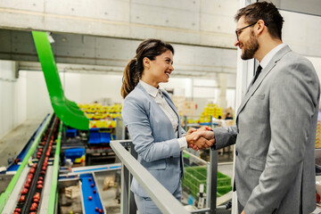 Wall Mural - Businesspeople making a good deal in fruit factory.