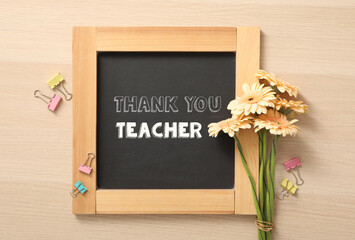 Sticker - Blackboard with phrase Thank You Teacher and flowers on wooden table, flat lay