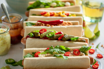 Wall Mural - Hot and homemade hot dogs with vegetables, sauce and herbs.