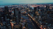 Beautiful Aerial Drone Pullback Reverse View Of Melbourne City, Victoria, Australia Above The Yarra River In The Very Early Morning At Dawn 