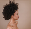 © Nexa - Side a smiling young Latin afro woman. Joy, positive and love. Beautiful african-style hair. Pastel studio background.
