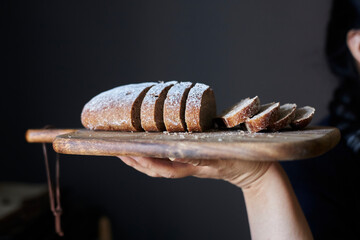 Wall Mural - girl holding homemade rye bread