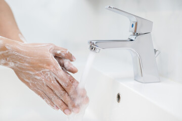 Wall Mural - Hygiene. Cleaning Hands. Washing hands with soap under the faucet with water Pay dirt.