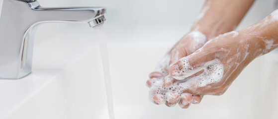 Wall Mural - Hygiene. Cleaning Hands. Washing hands with soap under the faucet with water Pay dirt.