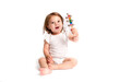 © nellas - One-year-old girl is playing with a rattle on a white background
