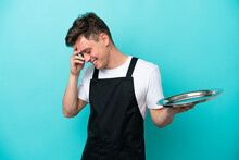 Young Waitress With Tray Isolated On Blue Background Laughing