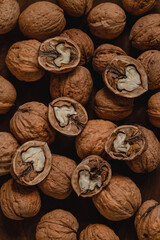 Wall Mural - Open walnuts and unpeeled walnuts. Walnuts pattern. Food background. Healthy diet with natural protein.