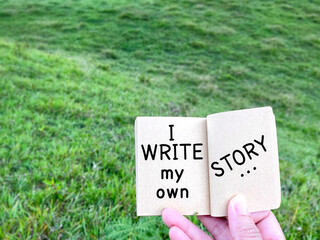Wall Mural - Motivational and inspirational quote - ‘ I write my own story’ on notepad. Text with green background.

