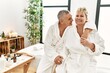 © Krakenimages.com - Senior caucasian couple smiling happy and hugging sitting on massage table at beauty center.