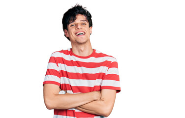 Poster - Handsome hipster young man wearing casual striped t shirt happy face smiling with crossed arms looking at the camera. positive person.