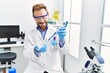 © Krakenimages.com - Middle age hispanic man wearing scientist uniform working at laboratory
