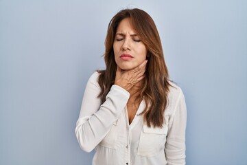 Sticker - Hispanic woman standing over isolated background touching painful neck, sore throat for flu, clod and infection