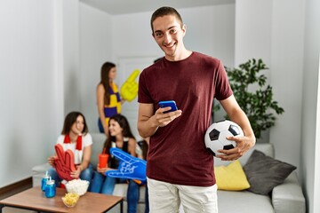 Poster - Group of young friends watching and supporting soccer match at home.