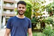 © Krakenimages.com - Young arab man smiling confident on a sunny day at the street