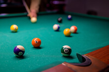 Colored Billiard Balls With Numbers On The Billiard Table In Front Of The Pocket.