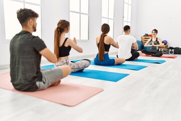 Sticker - Group of young people having yoga class with personal trainer at sport center.