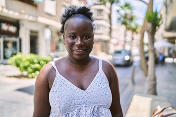 Canvas Print - Young african american woman smiling happy standing at the city.