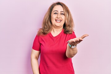 Poster - Middle age caucasian woman wearing casual clothes smiling friendly offering handshake as greeting and welcoming. successful business.