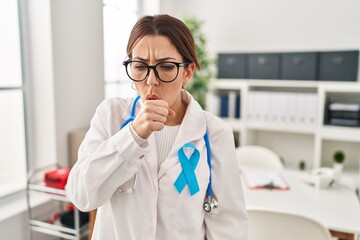 Canvas Print - Young brunette doctor woman wearing stethoscope at the clinic feeling unwell and coughing as symptom for cold or bronchitis. health care concept.