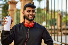 Young Arab Man Smiling Confident Holding Graffiti Spray At Street
