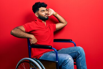 Poster - Arab man with beard sitting on wheelchair stretching back, tired and relaxed, sleepy and yawning for early morning