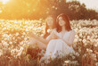 © Maya Kruchancova - two young beautiful girls on meadow with dandelions at sunset