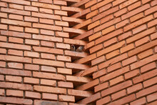 Two Sparrows In A Hole In A Red Brick Wall