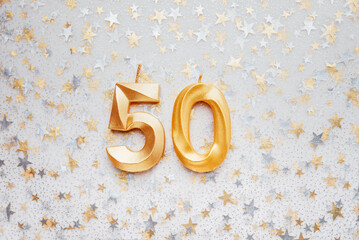 Wall Mural - Number 50 fifty golden celebration birthday candle on Festive Background. Ten years birthday. concept of celebrating birthday, anniversary, important date, holiday