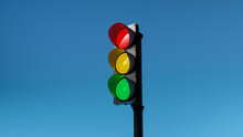 Traffic Light With Red, Yellow And Green Colors On Isolated On Blue Sky Background. Mock-up Or Source. 3d Render